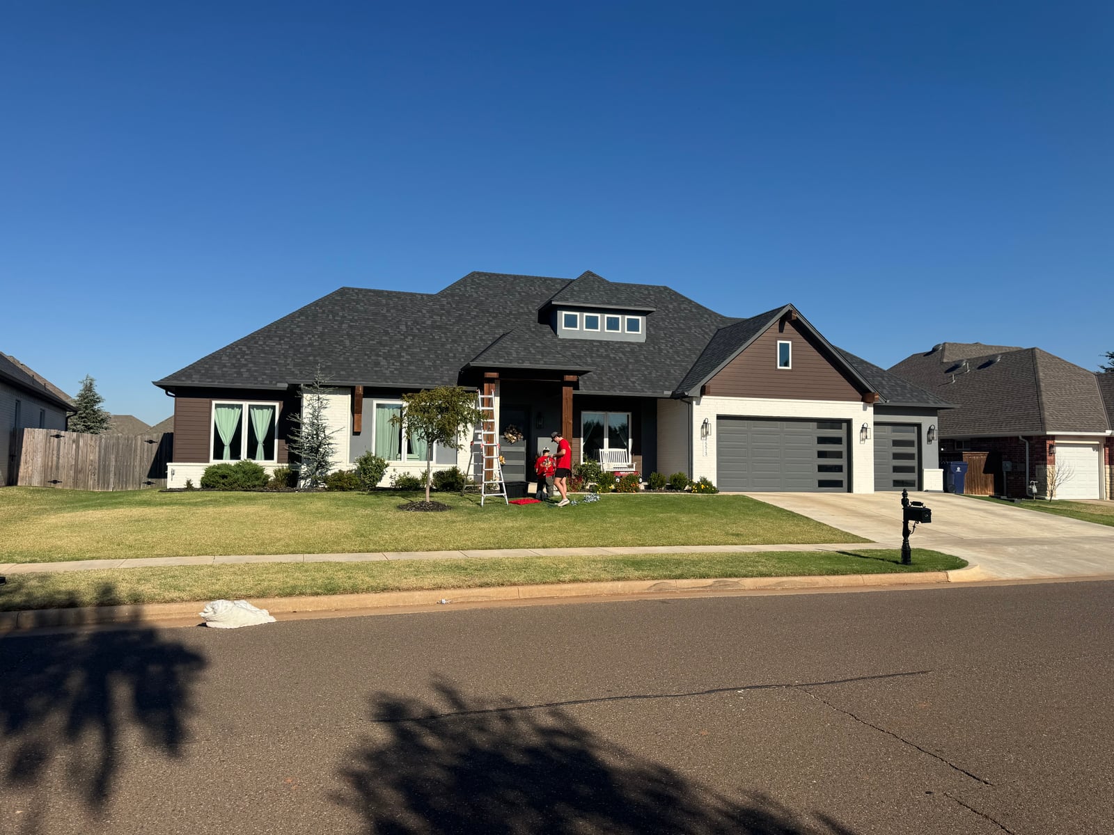 Christmas light installation on residential roofline in Edmond